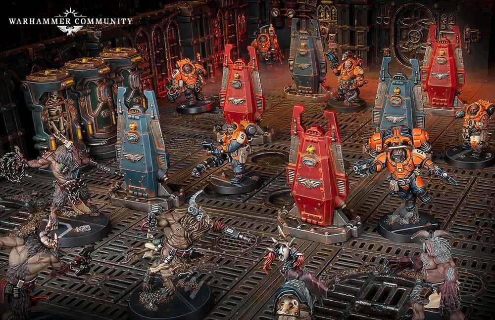 Miniature figures depict a sci-fi battle on the new terrain of Gallowfall, with armored warriors in orange and blue suits clashing against mutant creatures on a detailed, industrial-style grid. Perfect for fans of the Kill Team universe!